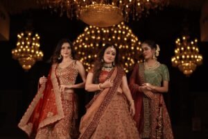 a group of women in Red designer bridal lehenga with intricate embroidery